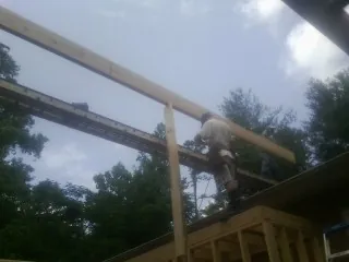 Carpenter setting a ridge beam over a new addition frame — Ice Dam Removal by Roofing Brothers in Mokelumne Hill