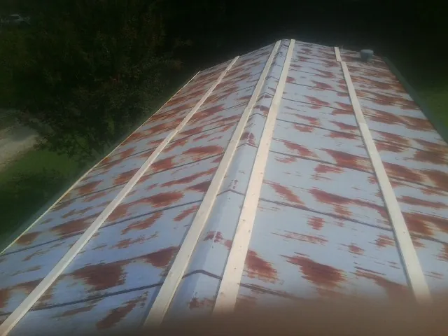 Rusted metal roof panels with new wood purlins before replacement — Storm Damage Roof Repair in Mokelumne Hill by Roofing Brothers