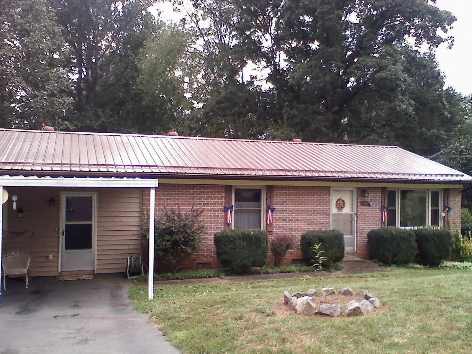 Bronze metal roof and carport on a brick ranch home — Roof Repair work by our crew in Mokelumne Hill