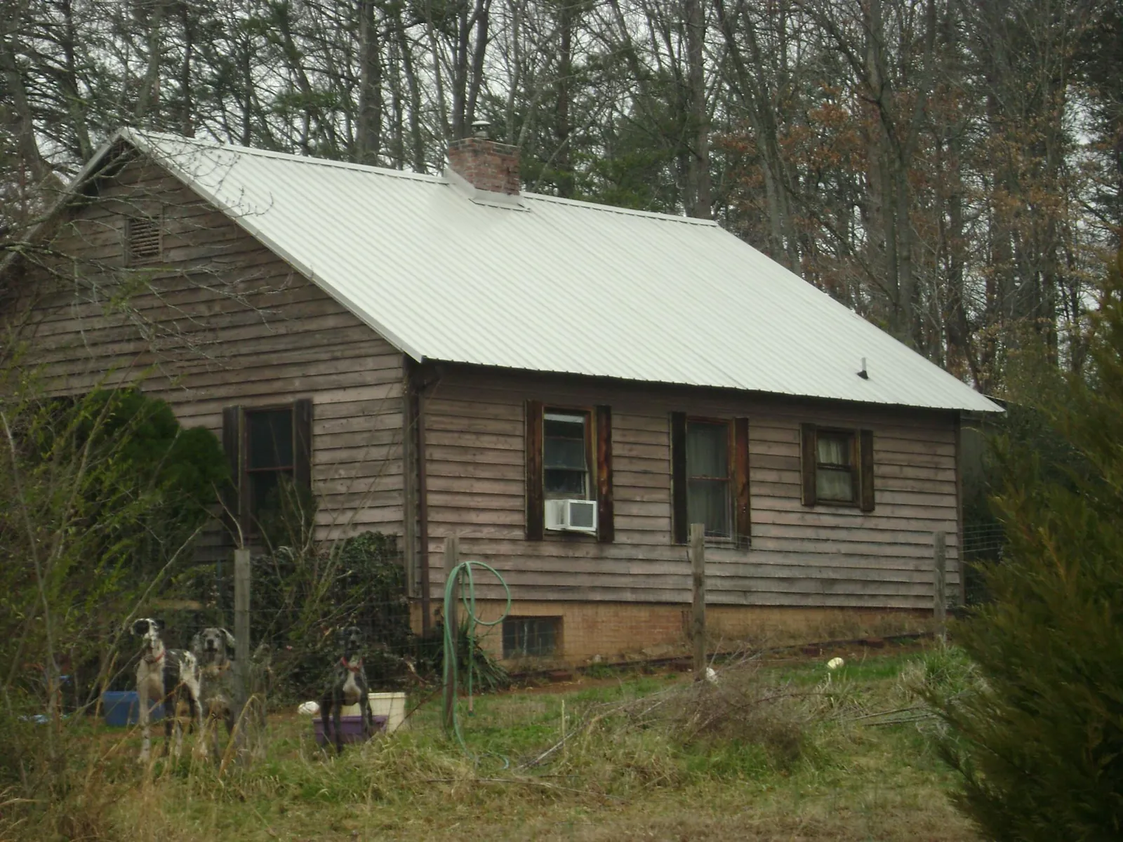 White metal roof on an old wood sided farmhouse, from a Metal Roof Installation job in Mokelumne Hill